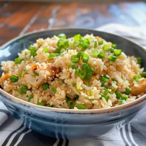 A bowl of simple Asian rice with peas and green onions.