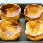 A plate of golden Yorkshire puddings.